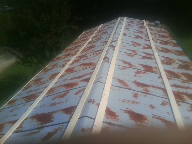 Rusted metal roof panels with new wood purlins before replacement — Storm Damage Roof Repair in Hammondsville by Roofing Brothers